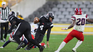 Aliquippa's Quentin Goode (4) attempts to juke McKeesport's Kemon Spell (20) during the first half of the WPIAL 4A Championship game Friday evening at Acrisure Stadium in Pittsburgh, PA.
