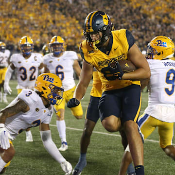 West Virginia Mountaineers Kole Taylor (87) leaps around Pittsburgh Panthers Donovan McMillon (3) for a touchdown during the first half at Milan Puskar Stadium in Morgantown, WV on September 16, 2023.