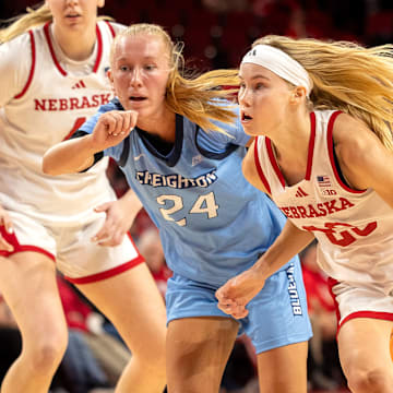 Nebraska guard Britt Prince drives to the basket while Creighton guard Ava Zediker defends.