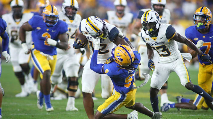 Brandon Hill (9) of the Pittsburgh Panthers drags down CJ Donaldson (12) of the West Virginia Mountaineers during the second half of the Backyard Brawl at Acrisure Stadium in Pittsburgh, PA on September 1, 2022.

Pitt Vs West Virginia Backyard Brawl