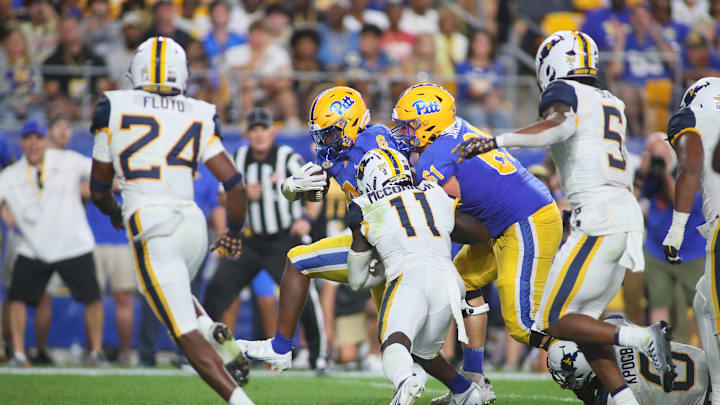 Rodney Hammond Jr. (6) of the Pittsburgh Panthers fights his way into the end zone during the second half of the Backyard Brawl against the West Virginia Mountaineers at Acrisure Stadium in Pittsburgh, PA on September 1, 2022.

Pitt Vs West Virginia Backyard Brawl