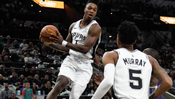 Dec 6, 2019; San Antonio, TX, USA; San Antonio Spurs guard Lonnie Walker IV (1) looks to pass to guard Dejounte Murray (5) after grabbing a rebound in the first half of the game against the Sacramento Kings at the AT&T Center. 