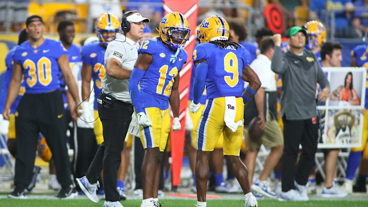 M.J. Devonshire (12) of the Pittsburgh Panthers celebrates with head coach Pat Narduzzi and teammate Brandon Hill (9) during the second half of the Backyard Brawl against the West Virginia Mountaineers

Pitt Vs West Virginia Backyard Brawl