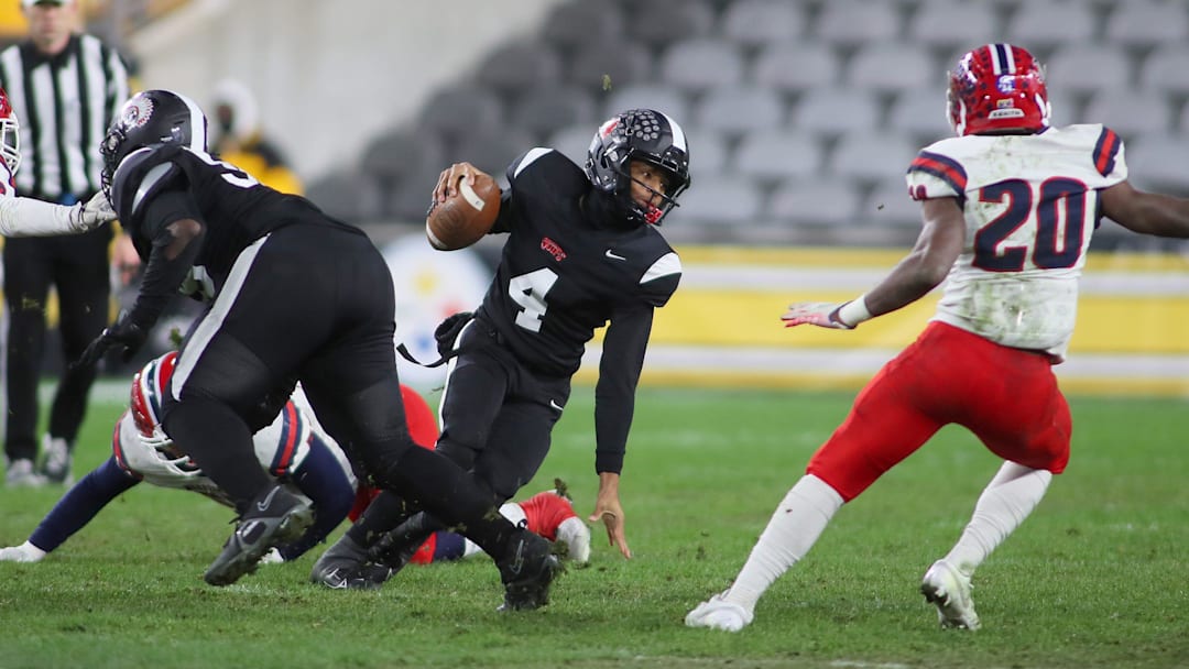Aliquippa's Quentin Goode (4) attempts to juke McKeesport's Kemon Spell (20) during the first half of the WPIAL 4A Championship game Friday evening at Acrisure Stadium in Pittsburgh, PA.