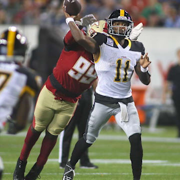 Pittsburgh Maulers Troy Willaims (11) throws downfield before being tackled by Birmingham Stallions Dondrea Tillman (99) during the second half of the USFL Championship game Saturday evening at Tom Benson Stadium in Canton, OH.