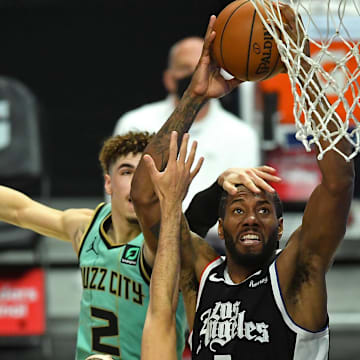 Los Angeles Clippers forward Kawhi Leonard (2) is fouled by Charlotte Hornets guard LaMelo Ball (2) as he goes up for a dunk in the second half of the game at Staples Center. Mandatory Credit: Jayne Kamin-Oncea-Imagn Images