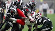 McKeesport's Kemon Spell (20) gets taken to the ground by multiple Aliquippa defenders during the second half of the WPIAL 4A Championship game Friday evening at Acrisure Stadium in Pittsburgh, PA.