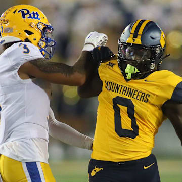 West Virginia Mountaineers Jaylen Anderson (0) exchange's words with Pittsburgh Panthers Donovan McMillon (3) during the first half at Milan Puskar Stadium in Morgantown, WV on September 16, 2023.