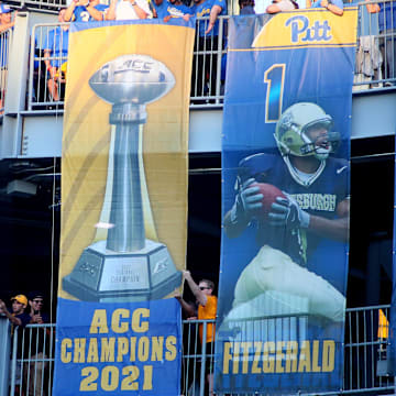 Former Pittsburgh Panthers including first round draft pick Kenny Pickett unveil the Panthers 2021 ACC Championship banner during the first half of the Backyard Brawl against the West Virginia Mountaineers at Acrisure Stadium in Pittsburgh, PA on September 1, 2022.

Pitt Vs West Virginia Backyard Brawl