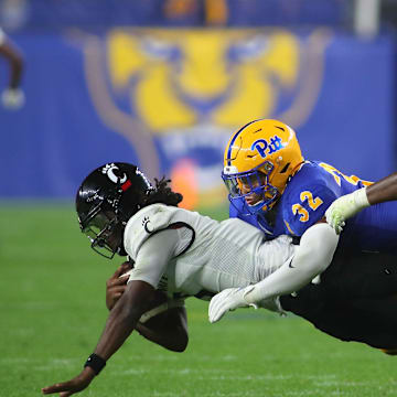 Cincinnati Bearcats Emory Jones (5) gets tackled by Pittsburgh Panthers Shayne Simon (32) during the second half at Acrisure Stadium in Pittsburgh, PA on September 9, 2023