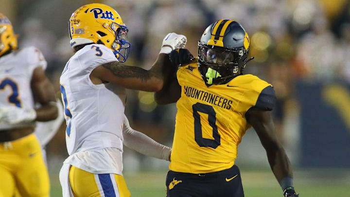 West Virginia Mountaineers Jaylen Anderson (0) exchange's words with Pittsburgh Panthers Donovan McMillon (3) during the first half at Milan Puskar Stadium in Morgantown, WV on September 16, 2023.