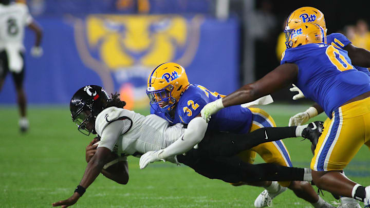 Cincinnati Bearcats Emory Jones (5) gets tackled by Pittsburgh Panthers Shayne Simon (32) during the second half at Acrisure Stadium in Pittsburgh, PA on September 9, 2023