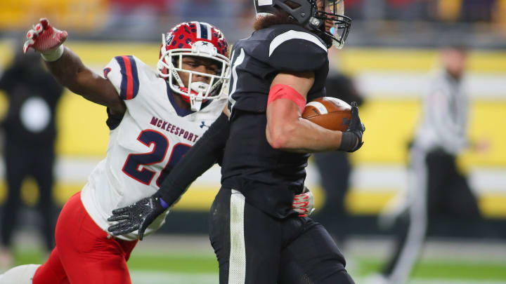 Aliquippa's Cameron Lindsey (11) pushes away from McKeesport's Kemon Spell (20) 