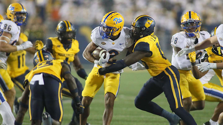 Pittsburgh Panthers Kenny Johnson (2) gets tackled by West Virginia Mountaineers Trey Lathan (19) during the second half at Milan Puskar Stadium in Morgantown, WV on September 16, 2023.