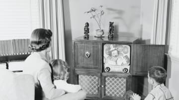 A vintage family enjoys the hit show of the day, 'Scary Clown Time.'