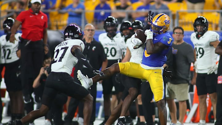 Pittsburgh Panthers Daejon Reynolds (3) attempts to haul in a pass as Cincinnati Bearcats Justin Harris (12) attempts to knock the ball away during the second half at Acrisure Stadium in Pittsburgh, PA on September 9, 2023