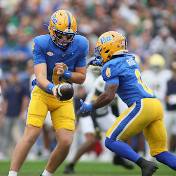 Pittsburgh Panthers quarterback Mason Heintschel (6) hands the ball off to running back Desmond Reid (0) during the first half against the Notre Dame Fighting Irish at Acrisure Stadium in Pittsburgh, PA on November 15, 2025.
