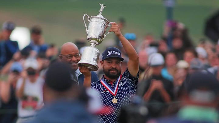 J.J. Spaun hoists his trophy in the air while celebrating his US Open Championship win at Oakmont Country Club.