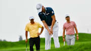 Golf stars Brooks Koepka and Min Woo Lee watch as Justin Thomas putts during the 125th U.S. Open at Oakmont Country Club 
