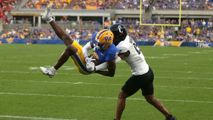 Pittsburgh Panthers Konata Mumpfield (9) hauls in a pass for a touchdown while being covered by Cincinnati Bearcats Taj Ward (15) during the first half at Acrisure Stadium in Pittsburgh, PA on September 9, 2023