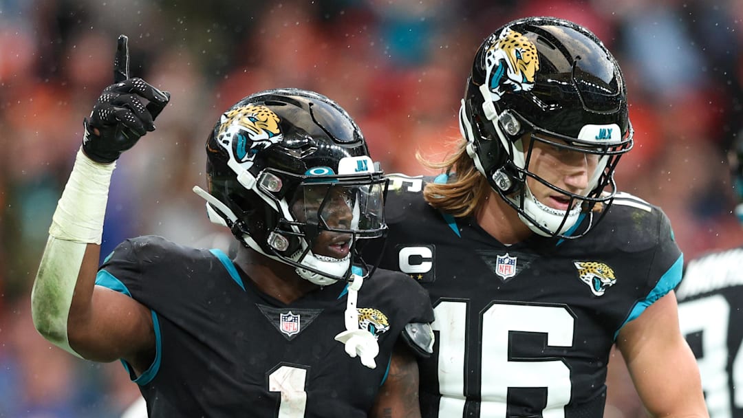 Oct 30, 2022; London, United Kingdom, Jacksonville Jaguars running back Travis Etienne Jr. (1) and quarterback Trevor Lawrence (16) react after scoring a touchdown against the Denver Broncos in the fourth quarter during an NFL International Series game at Wembley Stadium. Mandatory Credit: Nathan Ray Seebeck-Imagn Images