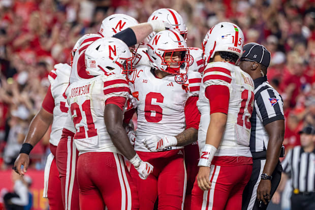 Nebraska players celebrate with wide receiver Dane Key after Key's 3-yard touchdown catch.
