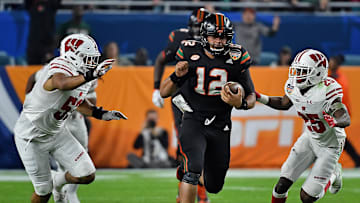 Dec 30, 2017; Miami Gardens, FL, USA; Miami Hurricanes quarterback Malik Rosier (12) runs the ball against the Wisconsin Badgers during the first half in the 2017 Orange Bowl at Hard Rock Stadium. Mandatory Credit: Jasen Vinlove-Imagn Images
