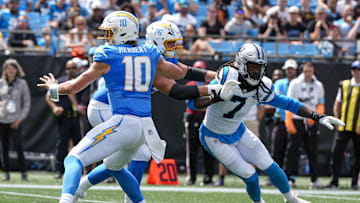 Sep 15, 2024; Charlotte, North Carolina, USA; Carolina Panthers linebacker Jadeveon Clowney (7) runs around end trying to pressure Los Angeles Chargers quarterback Justin Herbert (10) during the second quarter at Bank of America Stadium. Mandatory Credit: Jim Dedmon-Imagn Images