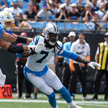 Sep 15, 2024; Charlotte, North Carolina, USA; Carolina Panthers linebacker Jadeveon Clowney (7) runs around end trying to pressure Los Angeles Chargers quarterback Justin Herbert (10) during the second quarter at Bank of America Stadium. Mandatory Credit: Jim Dedmon-Imagn Images