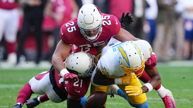 Chargers wide receiver Joshua Palmer catches a pass and fumbles between Cardinals defenders Zaven Collins and Trayvon Mullen.