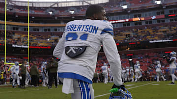 Detroit Lions cornerback Amik Robertson (21) kneels on the field during warmups prior to a game against Commanders