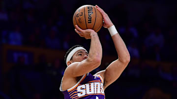 Dec 1, 2025; Los Angeles, California, USA; Phoenix Suns guard Devin Booker (1) shoots against the Los Angeles Lakers during the first half at Crypto.com Arena. Mandatory Credit: Gary A. Vasquez-Imagn Images