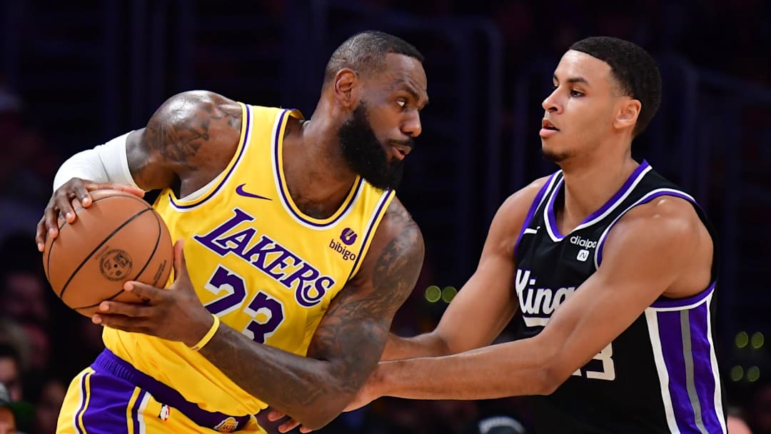 Mar 6, 2024; Los Angeles, California, USA;  Los Angeles Lakers forward LeBron James (23) moves the ball against Sacramento Kings forward Keegan Murray (13) during the first half at Crypto.com Arena.