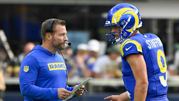 Oct 6, 2024; Inglewood, California, USA; Los Angeles Rams head coach Sean McVay talks to quarterback Matthew Stafford (9) during the third quarter against the Green Bay Packers at SoFi Stadium. Mandatory Credit: Robert Hanashiro-Imagn Images