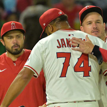 Angels relief pitcher Kenley Jansen (74) is congratulated by designated hitter Mike Trout (27) after earning a save in the ninth inning defeating the Texas Rangers at Angel Stadium on July 28.