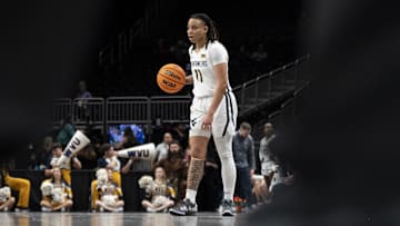 Mar 7, 2025; Kansas City, MO, USA; West Virginia Mountaineers guard JJ Quinerly (11) handles the ball against the Kansas State Wildcats in the second quarter at T-Mobile Center. Mandatory Credit: Amy Kontras-Imagn Images