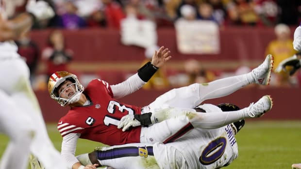 San Francisco 49ers quarterback Brock Purdy (13) is tackled by Baltimore Ravens linebacker Roquan Smith