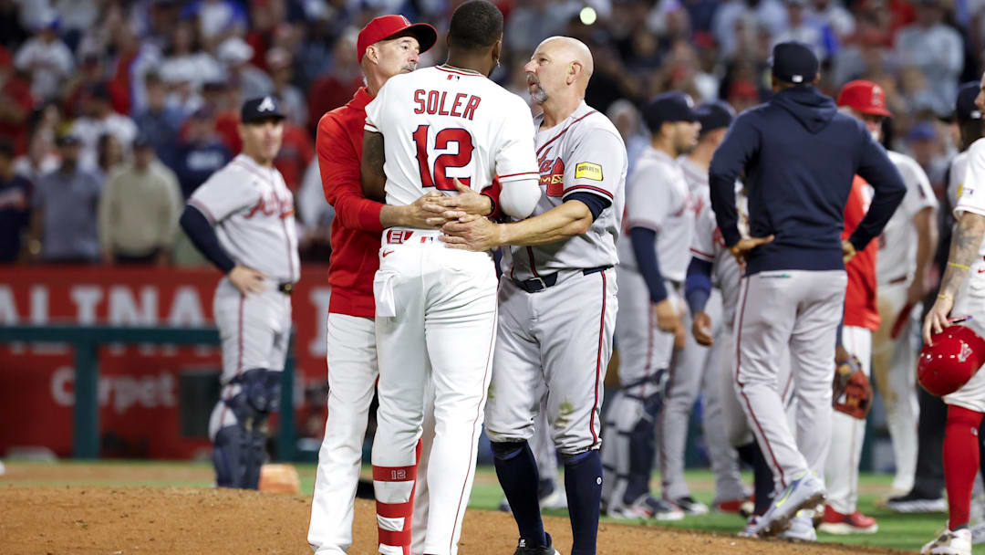 Apr 7, 2026; Anaheim, California, USA; Los Angeles Angels right fielder Jorge Soler (12) speaks with coaching staff after a fight breaks out with Atlanta Braves pitcher Reynaldo López (40) during the fifth inning at Angel Stadium. Mandatory Credit: William Navarro-Imagn Images