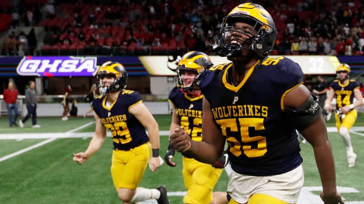 Prince Avenue's Christian Garrett (55) celebrates after winning the 2023 GHSA high school football Class A-Division 1 championship game. Garrett, a 4-star defensive lineman who recently de-committed from the University of Georgia, will lead PAC into its season opener at West Forsyth.