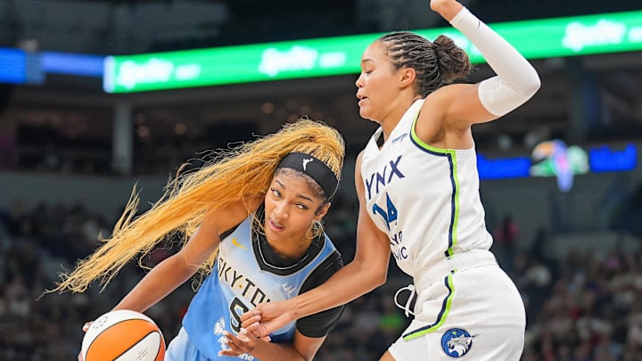 Jul 22, 2025; Minneapolis, Minnesota, USA; Chicago Sky forward Angel Reese (5) dribbles against the Minnesota Lynx forward Napheesa Collier (24) in the second quarter at Target Center. Mandatory Credit: Brad Rempel-Imagn Images