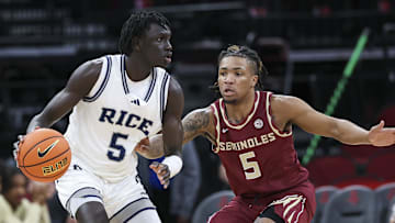 Nov 9, 2024; Houston, Texas, USA; Rice Owls guard Jacob Dar (5) controls the ball as Florida State Seminoles guard Daquan Davis (5) defends during the first half at Toyota Center. Mandatory Credit: Troy Taormina-Imagn Images