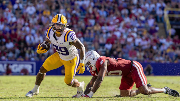 Nov 15, 2025; Baton Rouge, Louisiana, USA;  LSU Tigers running back Caden Durham (29) runs away from the tackle from the Arkansas Razorbacks during the second half at Tiger Stadium. Mandatory Credit: Stephen Lew-Imagn Images