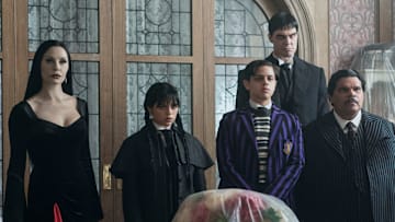 Catherine Zeta-Jones as Morticia Addams, Jenna Ortega as Wednesday Addams, Isaac Ordonez as Pugsley Addams, Joonas Suotamo as Lurch, Luis Guzmán as Gomez Addams in episode 201 of Wednesday