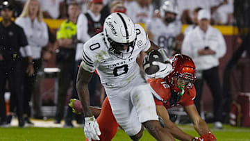 Iowa State Cyclones' wide receiver Chase Sowell (0) breaks a tackle from Arizona Wildcats defensive back Genesis Smith (12) after making a catch during the fourth quarter in the Big-12 conference showdown on Sept. 27, 2025, at Jack Trice Stadium in Ames, Iowa.