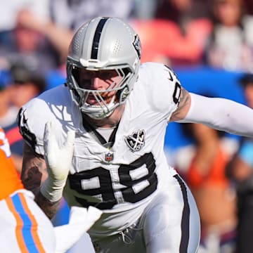 Oct 6, 2024; Denver, Colorado, USA; Las Vegas Raiders defensive end Maxx Crosby (98) chases down Denver Broncos quarterback Bo Nix (10) for a sack in the second half at Empower Field at Mile High. 