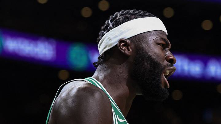 Oct 23, 2026; Boston, Massachusetts, USA; New York Knicks center Karl-Anthony Towns (32) holds the ball as Boston Celtics center Neemias Queta (88) celebrates a basket during the second half at TD Garden. Mandatory Credit: Winslow Townson-Imagn Images