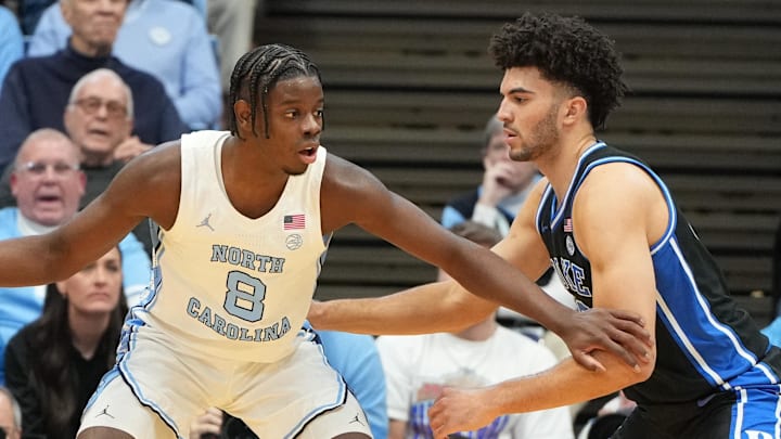 Feb 7, 2026; Chapel Hill, North Carolina, USA; North Carolina Tar Heels forward Caleb Wilson (8) with the ball as Duke Blue Devils forward Cameron Boozer (12) defends in the first half at Dean E. Smith Center. Mandatory Credit: Bob Donnan-Imagn Images