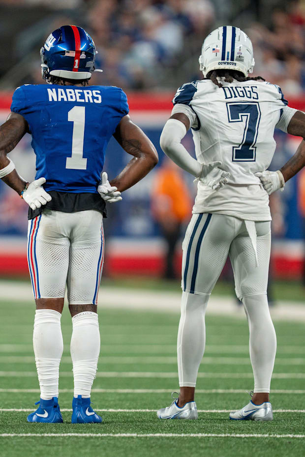 New York Giants wide receiver Malik Nabers and Dallas Cowboys cornerback Trevon Diggs wait for a review at MetLife Stadium. 