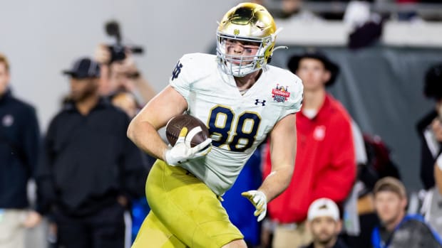 Notre Dame Fighting Irish tight end Mitchell Evans scores a touchdown during a college football game.