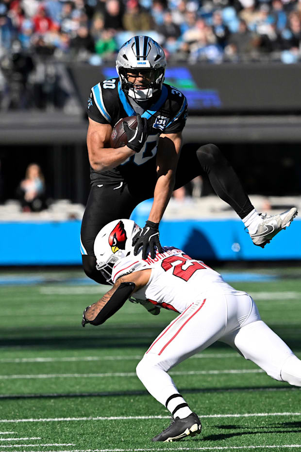 Carolina Panthers running back Chuba Hubbard jumps over Arizona Cardinals cornerback Sean Murphy-Bunting